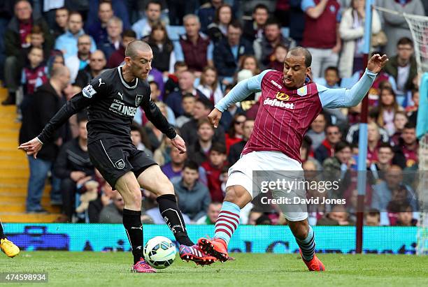 Gabriel Agboniahor of Aston Villa is tackled by David Jones of Burnley during the Barclay's Premier League match at Villa Park on May 24, 2015 in...