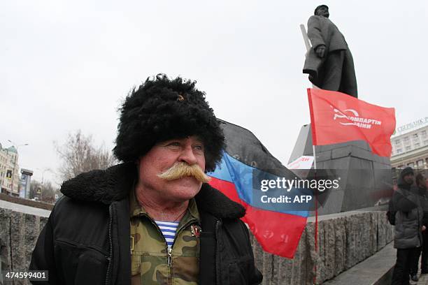 An activist of the Ukrainian Communist party together with a few others stands at the Lenin monument in the center of the industrial city of Donetsk...