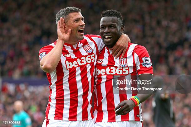 Mame Biram Diouf of Stoke City celebrates scoring a goal with his team mate Jonathan Walters during the Barclays Premier League match between Stoke...