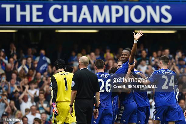 Chelsea's Ivorian striker Didier Drogba is carried off the pitch by teammates after being substituted during the English Premier League football...