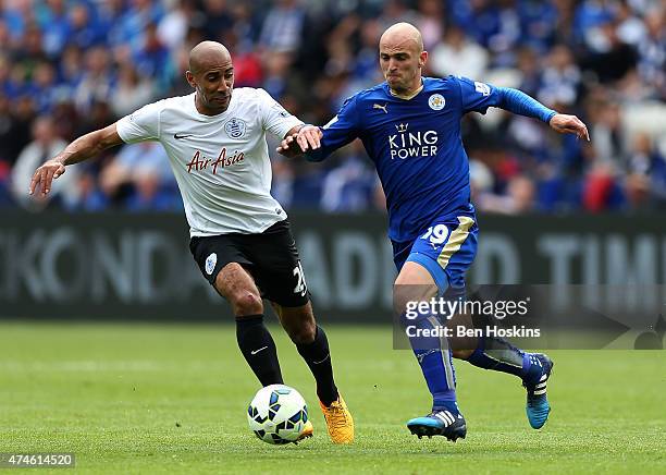 Esteban Cambiasso of Leicester holds off pressure from Karl Henry of QPR during the Barclays Premier League match between Leicester City and Queens...