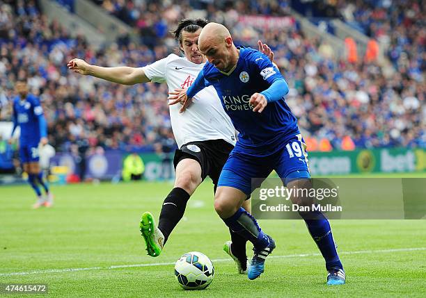 Esteban Cambiasso of Leicester City and Joey Barton of QPR compete for the ball during the Barclays Premier League match between Leicester City and...