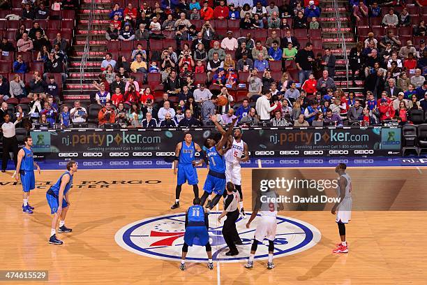 Samuel Dalembert of the Dallas Mavericks goes up for the opening tip against Arnett Moultrie of the Philadelphia 76ers on February 21, 2014 at the...