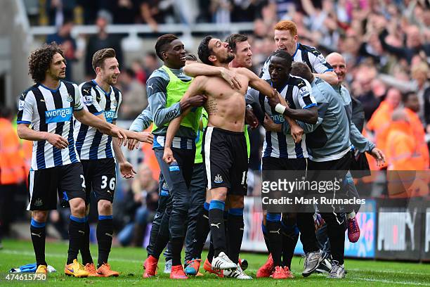 Jonas Gutierrez of Newcastle United celebrates scoring his team's second goal with his team mates during the Barclays Premier League match between...