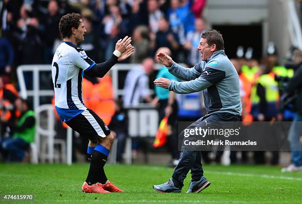 John Carver manager of Newcastle United and Daryl Janmaat of Newcastle United celebrate their team's second goal during the Barclays Premier League...