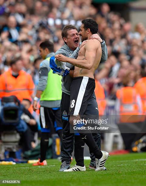 Newcastle coach John Carver congratulates Jonas Gutierrez after the second goal during the Barclays Premier League match between Newcastle United and...