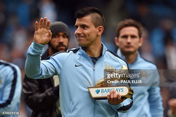 Manchester City's Argentinian striker Sergio Aguero gestures holding the Premier League Golden Boot for being the top goalscorer in the league after...