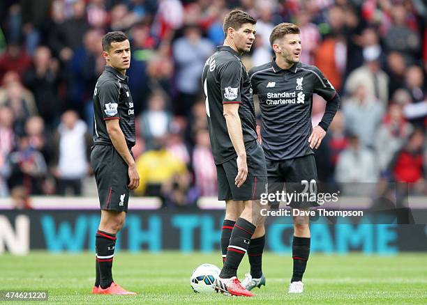 Philippe Coutinho, Steven Gerrard and Adam Lallana of Liverpool react during the Barclays Premier League match between Stoke City and Liverpool at...