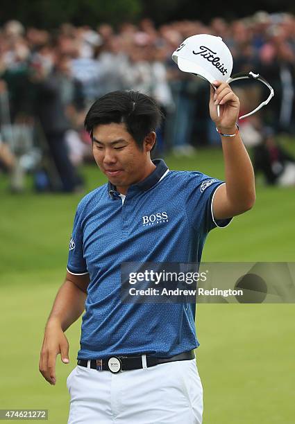 Byeong-Hun An of South Korea acknowledges the crowd on the 18th green during day 4 of the BMW PGA Championship at Wentworth on May 24, 2015 in...