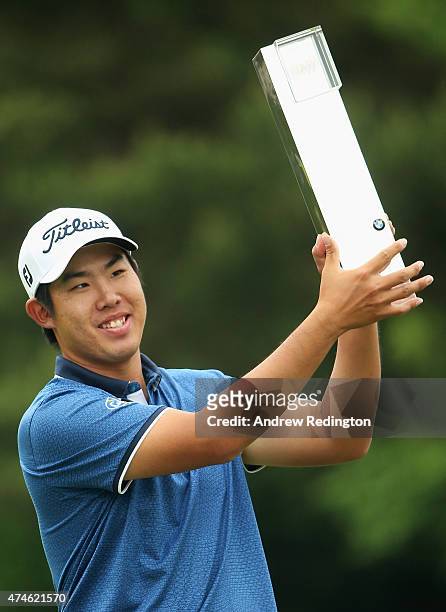 Byeong-Hun An of South Korea holds the trophy aloft following his victory during day 4 of the BMW PGA Championship at Wentworth on May 24, 2015 in...
