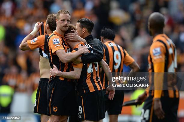 Hull City's Irish midfielder David Meyler embraces Hull City's Irish midfielder Stephen Quinn after the final whistle of the English Premier League...