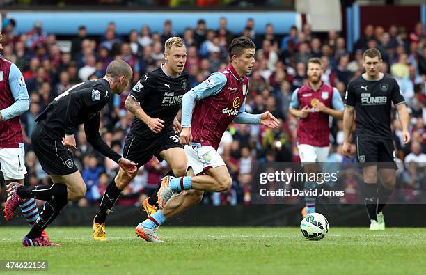 Jack Gralish of Aston Villa evades David Jones of Burnley during the Barclays Premier League match between Aston Villa and Burnley at Villa Park on...