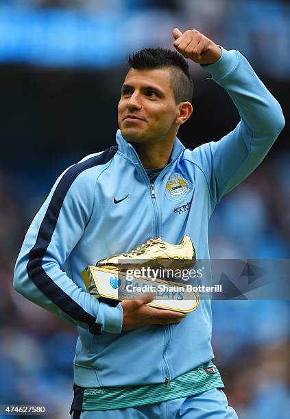 Sergio Aguero of Manchester City holding the golden boots trophy waves to supporters after the Barclays Premier League match between Manchester City...