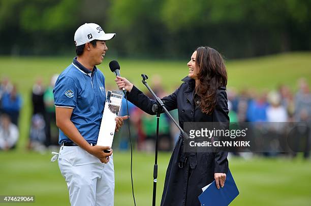 Korean golfer Byeong Hun An is interviewed by Kirsty Gallagher on the 18th green after winning the PGA Championship at Wentworth Golf Club in Surrey,...