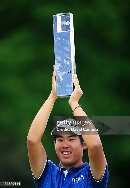 Byeong-Hun An of South Korea holds the trophy aloft following his victory during day 4 of the BMW PGA Championship at Wentworth on May 24, 2015 in...