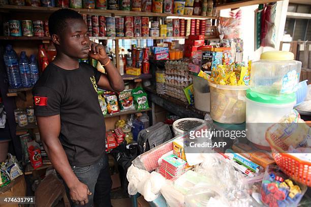Kingsley Adukpo stands in his shop in Accra on February 11, 2014. Adukpo had to repeatedly raise his prices due to the weakening Cedi . Ghana's...