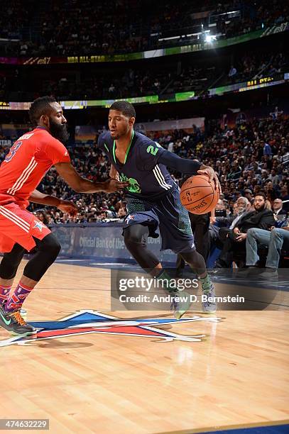 Paul George of the Eastern Conference drives to the basket against James Harden of the Western Conference during the 2014 NBA All-Star Game as part...