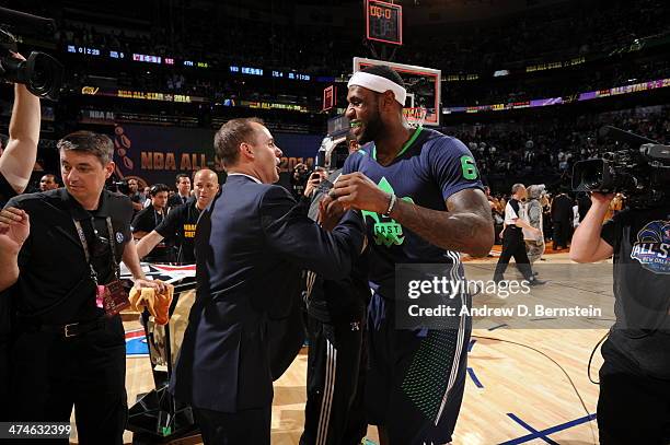 Frank Vogel celebrates with LeBron James of the Eastern Conference after defeating the Western Conference during the 2014 NBA All-Star Game as part...