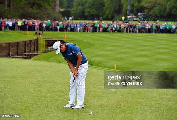 Korean golfer Byeong Hun An rolls in his final putt on the 18th green to win the PGA Championship at Wentworth Golf Club in Surrey, south west of...
