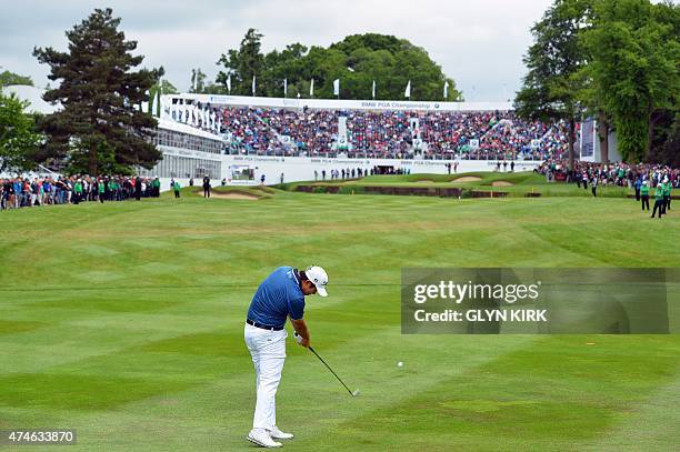 Korean golfer Byeong Hun An plays his approach shot to the 18th green on his way to winning the PGA Championship at Wentworth Golf Club in Surrey,...