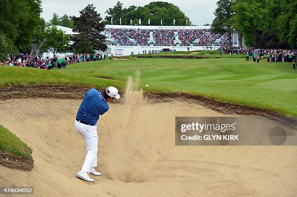 Korean golfer Byeong Hun An plays his second shot from a fairway bunker on the 18th hole on his way to winning the PGA Championship at Wentworth Golf...