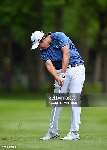 Korean golfer Byeong Hun An plays his approach shot to the 17th green on his way to winning the PGA Championship at Wentworth Golf Club in Surrey,...