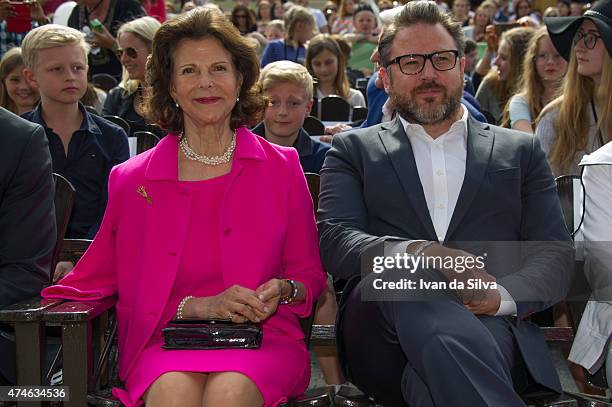 Queen Silvia of Sweden, CEO Grona Lund Magnus Widell attends The Childhood Day in Stockholm on May 24, 2015 in Stockholm, Sweden. .