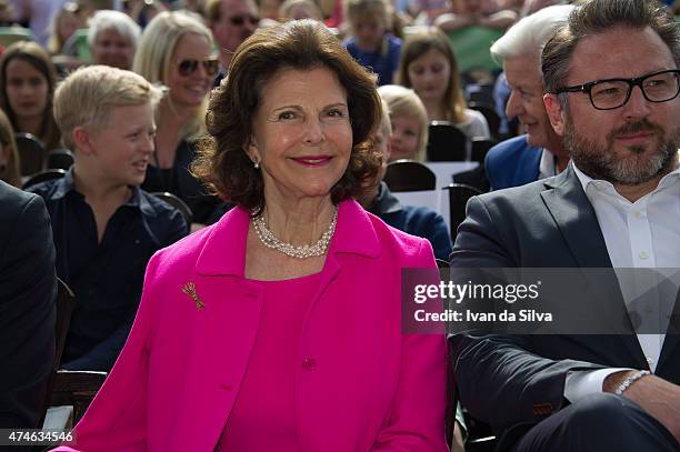 Queen Silvia of Sweden, CEO Grona Lund Magnus Widell attends The Childhood Day in Stockholm on May 24, 2015 in Stockholm, Sweden. .