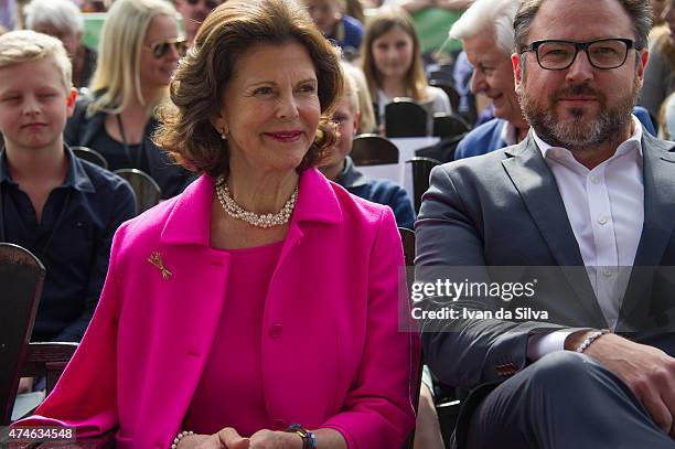 Queen Silvia of Sweden, CEO Grona Lund Magnus Widell attends The Childhood Day in Stockholm on May 24, 2015 in Stockholm, Sweden. .