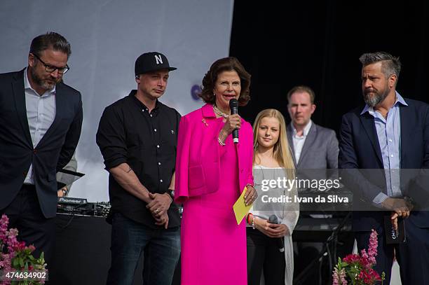 Grona Lund Magnus Widell, Petter, Queen Silvia of Sweden and Program Manager Kenny Mattson attends the Childhood day at Djurgarden on May 24, 2015 in...