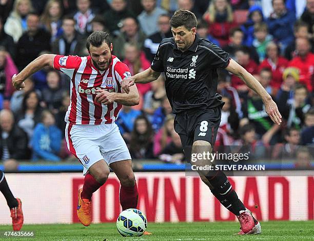 Liverpool's English midfielder Steven Gerrard vies with Stoke City's Dutch defender Erik Pieters during the English Premier League football match...