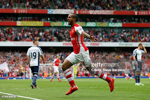 Theo Walcott of Arsenal celebrates scoring his team's second goal during the Barclays Premier League match between Arsenal and West Bromwich Albion...
