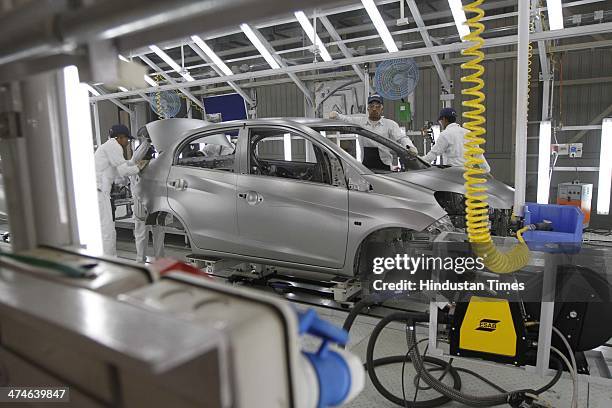 The assembly line of the Honda Amaze car is pictured inside the company's manufacturing plant at Tapukara on February 24, 2014 in Alwar, India. The...