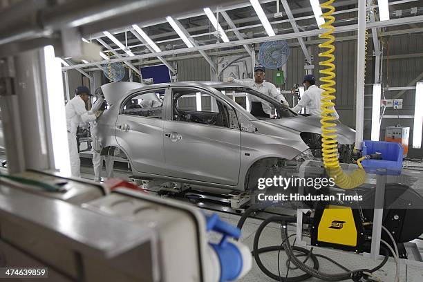 The assembly line of the Honda Amaze car is pictured inside the company's manufacturing plant at Tapukara on February 24, 2014 in Alwar, India. The...