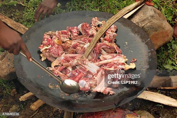 butchers cooking meat on wood fire in nature - camping with bone fire stock pictures, royalty-free photos & images