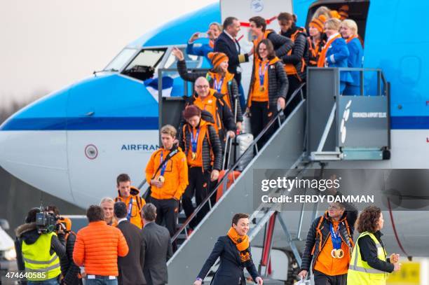 Dutch skater Sven Kramer waves moments after leaving the plane carrying the Dutch Olympic team, after landing in Groningen Airport Eelde near Eelde...