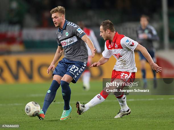 Florian Trinks of Fuehrt passes the ball beside Matthias Lehmann of Cologne during the Second Bundesliga match between 1. FC Koeln and Greuther...