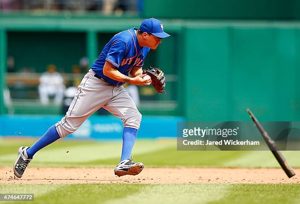 Wilmer Flores of the New York Mets avoids a flying broken bat while fielding a ground ball against the Pittsburgh Pirates during the game at PNC Park...