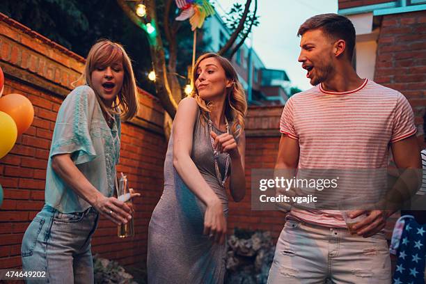 heureux jeunes danser au parti jardin. - femme enceinte jardin photos et images de collection