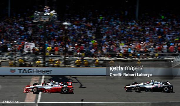 Juan Pablo Montoya of Colombia driver of the Team Penske Chevrolet Dallara crosses the finish line to win the 99th running of the Indianapolis 500...