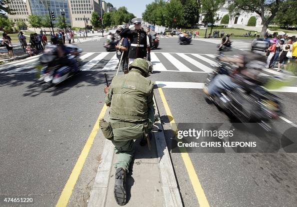 Marine Corps Staff Sargeant Tim Chambers salutes riders during The ...