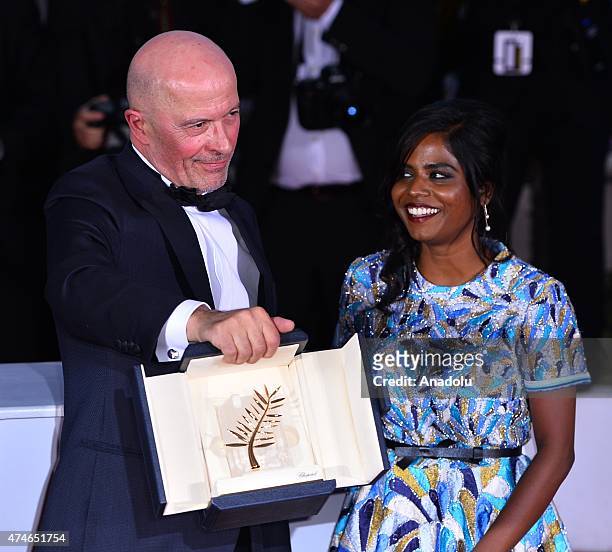 French director Jacques Audiard poses with Sri Lankan actress Kalieaswari Srinivasan during the Award Winners photocall after he won the Palme d'Or...