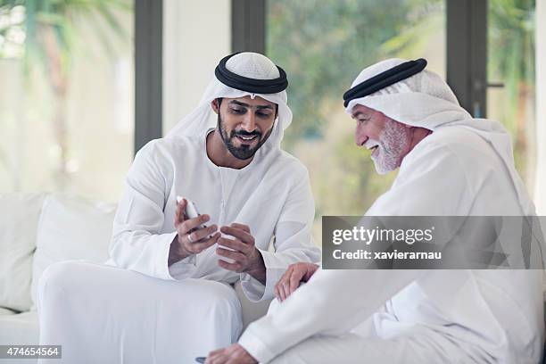 showing his social media pictures - emirati culture stock pictures, royalty-free photos & images