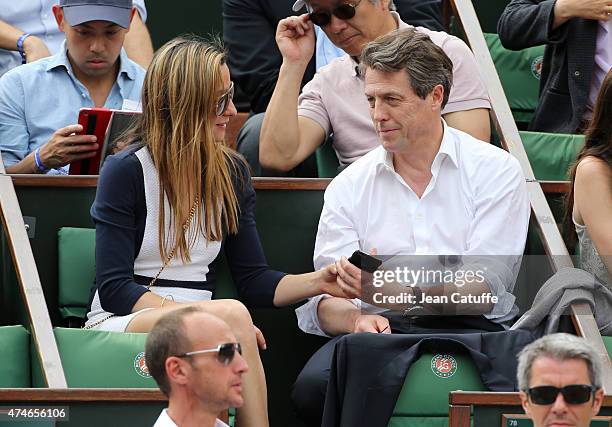 Hugh Grant and Anna Elisabet Eberstein attend day 1 of the French Open 2015 held at Roland Garros on May 24, 2015 in Paris, France.