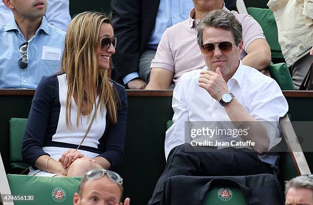 Hugh Grant and Anna Elisabet Eberstein attend day 1 of the French Open 2015 held at Roland Garros on May 24, 2015 in Paris, France.
