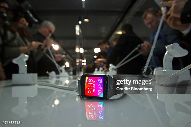 Galaxy Gear 2 wearable device sits on a display table while media inspect the latest Samsung Electronics Co. Hardware during a news conference on the...