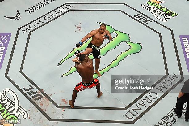 Daniel Cormier lands a kick to the head of Anthony 'Rumble' Johnson in their UFC light heavyweight championship bout during the UFC 187 event at the...