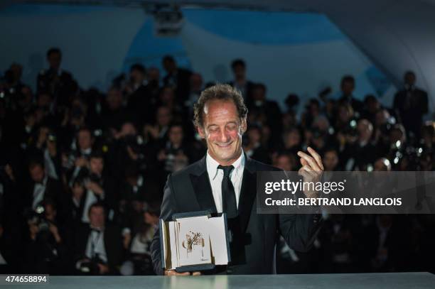 French actor Vincent Lindon poses with his prize during a photocall after he was awarded with the Best Actor prize during the closing ceremony of the...