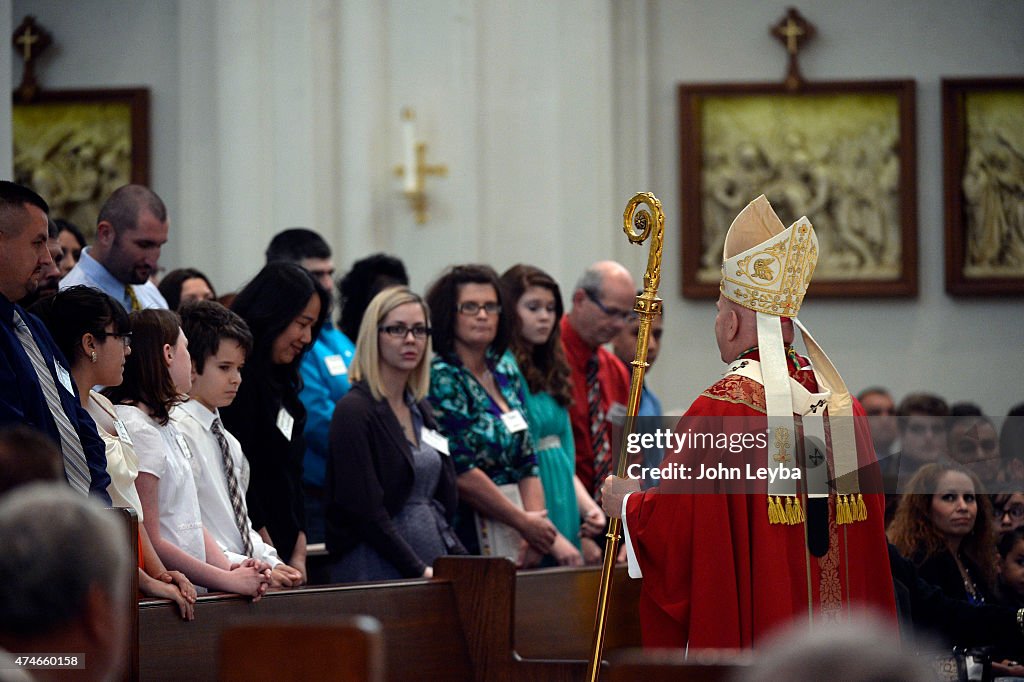 Children and adulst receive the Rite of Confirmation at Cathedral Basilica of the Immaculate Conception