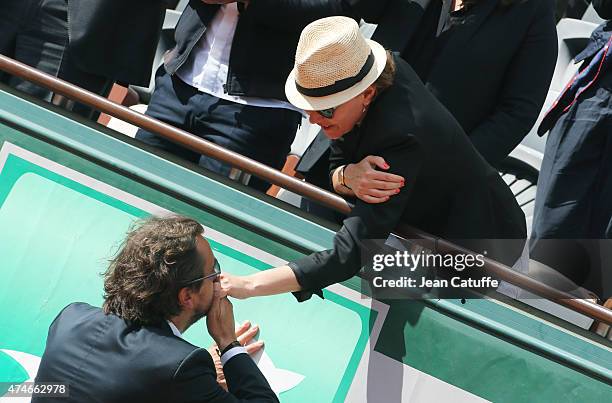 Henri Leconte greets Cendrine Dominguez after the tribute on Center Court honoring Cendrine's late husband, French tennis champion Patrice Dominguez...